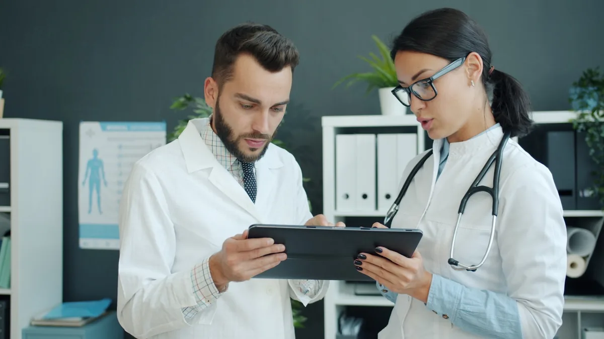 Two clinicians discussing reviewer comments